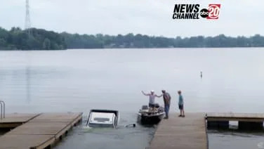 Watch this GMC Sierra pickup slide down a boat launch into a lake